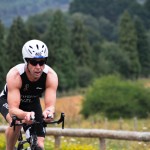 Man cycling through country lanes in cycle gear with helmet